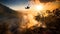 Helicopter drops water on wildfire in rugged terrain, backlit by a setting sun filtered through smoke.
