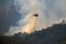 Helicopter dumping water on forest fire