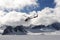 Helicopter flying over glacier