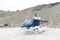 Helicopter from The Helicopter Line Company landing on snowcapped mountain peak around Aoraki Mount Cook and Mount Cook National