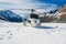 Helicopter Landing on a Snow Mountain