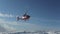 The helicopter left skiers on the slope of the mountain and flew raising a cloud of snow