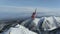 The helicopter left skiers on the slope of the mountain and flew raising a cloud of snow