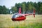 Helicopter Robinson R44 in a meadow near Nida airoport.