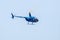 Helicopter Robinson R44 Raven in blue sky