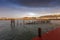 Heligoland - harbor with pier and colorful houses at sunrise with dramatic sky