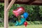 Helium filled birthday party balloon in a shape of a mermaid with two smaller blue and red balloons