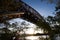 Hell Gate Bridge and river before sunset in silhouette