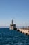 A Hellenic Navy patrol fighter in the port of Rhodes against blue skies. Turkish mainland in the background