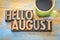 Hello August word abstract in wood type