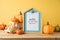 Hello Autumn concept with picture frame, toy truck and pumpkin decor on wooden table over yellow background. Fall season greeting