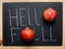 Hello Fall Hand Lettering Typography with Ripe Red Pomegranates on Black Chalkboard. Autumn Harvest Thanksgiving.