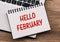 Hello february - inscription on notepad on laptop keyboard