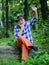 Hello. mature man with beard in cowboy hat. farmer sit on wood. happy forester. human and nature. hiking in deep wood