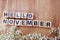 Hello november alphabet letters on wooden background