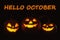 Hello October card. Halloween pumpkin heads glowing