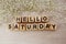 Hello saturday alphabet letters on wooden background