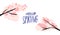 Hello spring handwritten text on white background decorated with two pink cherry blossom branches with blooming flowers