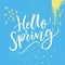 Hello spring text, modern calligraphy at blue grunge background with hand marks