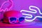 Hello Summer with hat and sunglasses refection flamingo neon light with cactus on  pink and blue light on table with copy space.