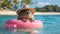 Hello Summer. Super cute capybara wearing straw hat and swimming in the pool. Ai generated image