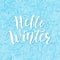 Hello winter. Blue Hand lettering quote logo with frozen texture. Brush Calligraphic design. Vector illustration.