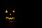 Helloween symbol with mad face, glowing eyes, mouth and teeth