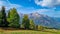 Helm - Alpine meadow in golden autumn with panoramic view of majestic mountain range of untamed Sexten Dolomites