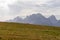 Helm - Alpine meadow in golden autumn with panoramic view of majestic mountain range of untamed Sexten Dolomites