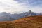 Helm - Alpine meadow in golden autumn with panoramic view of majestic mountain range of untamed Sexten Dolomites