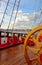 Helm wheel of an old wooden sailboat. Details of the deck of the ship