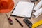 Helmet, blank architectural drawing, drawing compass, drawing tools on wood table.