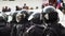 Helmet crowd armed policeman on street close up protect order 4K. Strike people.