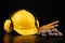 Helmet, gloves and scoop on a dark workbench. Safety and hygiene accessories for construction workers.