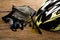 Helmet, gloves and water bottle - bicycle accessories on Wood.