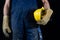 Helmet held by a construction worker. Protective clothing for ma