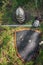 The helmet, saber and glove of the warrior lie on the ground in a tall green grass.  Lost, taken after the battle.