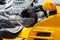 Helmet on the steering wheel of a beautiful powerful sports bright yellow motorcycle. Close-up