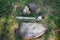 A helmet, a sword, a steel glove and a shield of a Mongolian warrior lie on the ground in a tall green grass.