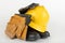 Helmet, work boots and gloves on a white table. Workwear for the production worker