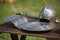 Helmets, Shields and Medieval Metallic Armors and Weapons, Outdoors on Wooden Table