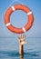 Help concept. Lifebuoy for drowning man\'s hand in