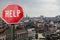 Help stop sign with view of Brussels, Belgium