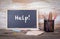 Help text on a blackboard. Old wooden table with texture