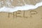 HELP written on sand