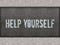 HELP YOURSELF painted on metal panel wall.