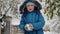 A helper in the heart of winter, a kid faces the storm\'s fury, shoveling snow to clean his icy driveway