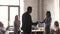 Helpful african american male boss handshake congratulate happy female employee