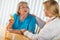 Helpful Doctor Talking with Senior Adult Woman About Medicine Prescription