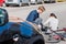 Helpful young man giving first aid to an injured woman after bicke accident